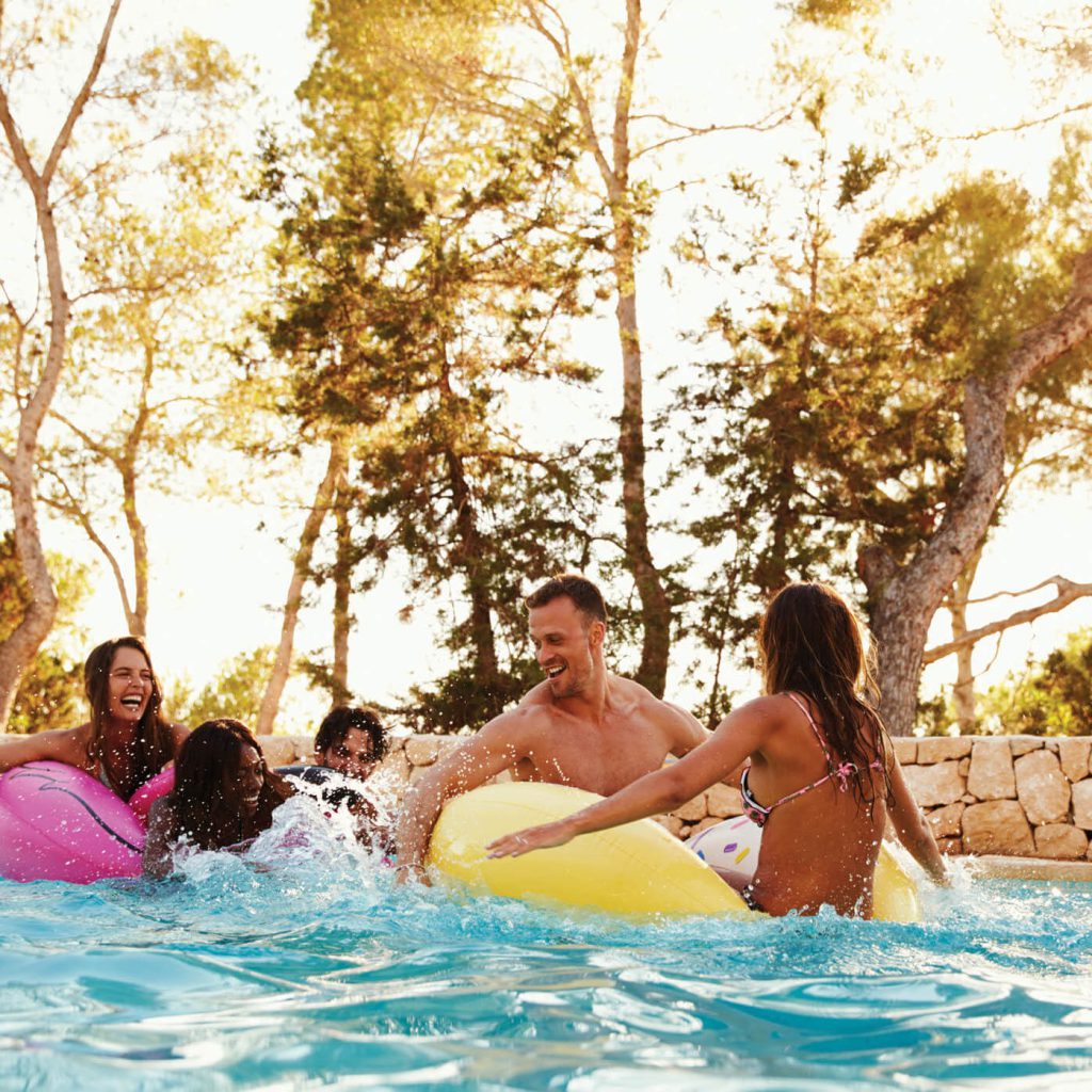 Family swimming in pool